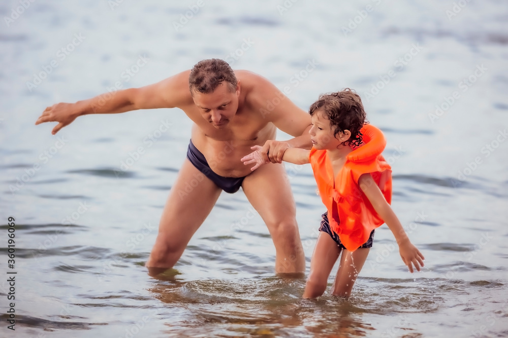 Father with son swimming in sea, travel, summer Father with son swimming in sea, travel, summer