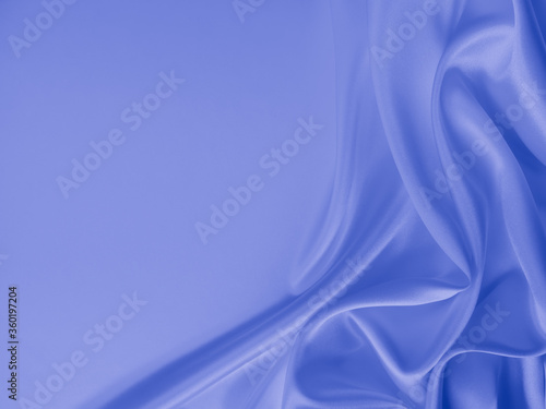 Smooth elegant wavy blue satin silk luxury cloth fabric texture, abstract background design.