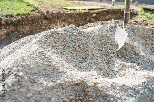 Pile of gravel sand with a shovel