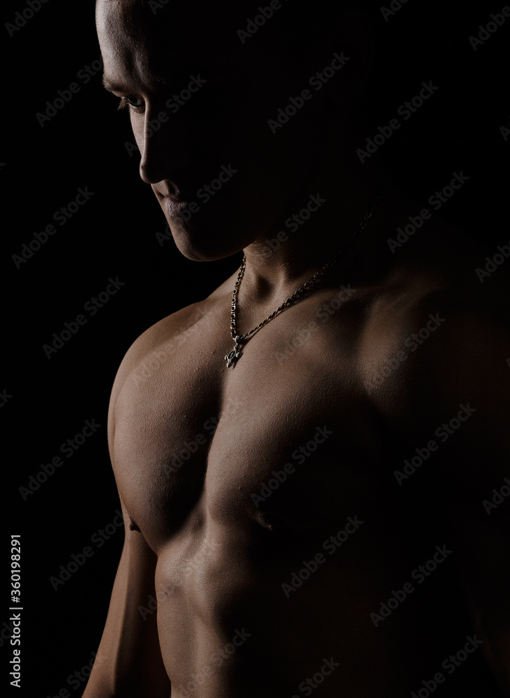 A guy with a handsome torso. The man is naked, a healthy muscular guy, a man’s torso. Posing in the studio A guy with a handsome torso. The man is naked, a healthy muscular guy, a man’s torso. Posing in the studio