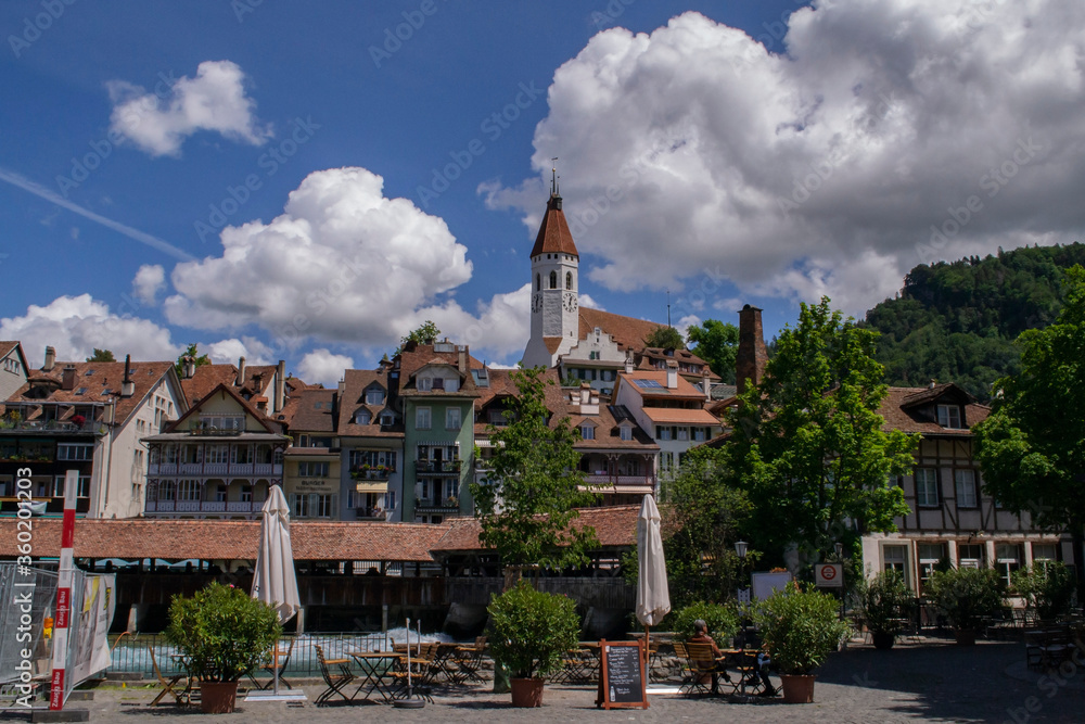 view of the Thun Castle in Switzerland in Thun, as well as beautiful houses by the river