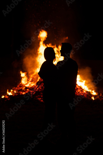 couple in front of a giant bonfire