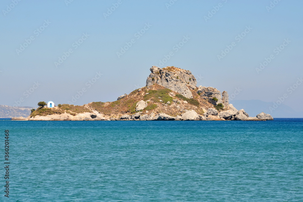 A small chapel on a rocky island in the Mediterranean