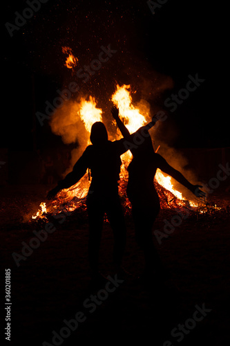 two friends in front of a giant fire