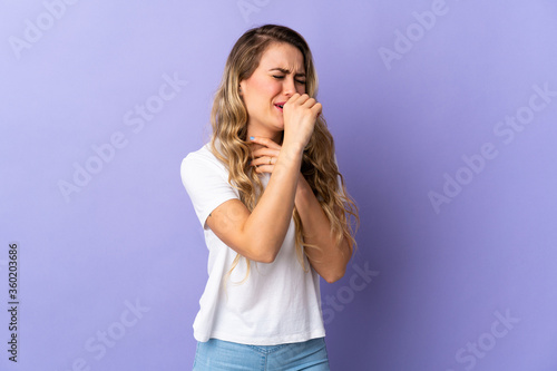 Young Brazilian woman isolated on purple background coughing a lot