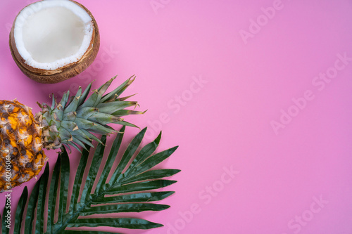 tropical background pink with coconut and pineapple top view. High quality photo