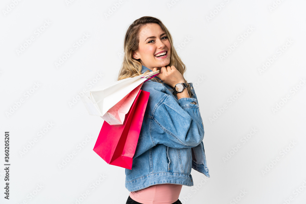 Young Brazilian woman isolated on white background holding shopping bags and smiling Young Brazilian woman isolated on white background holding shopping bags and smiling