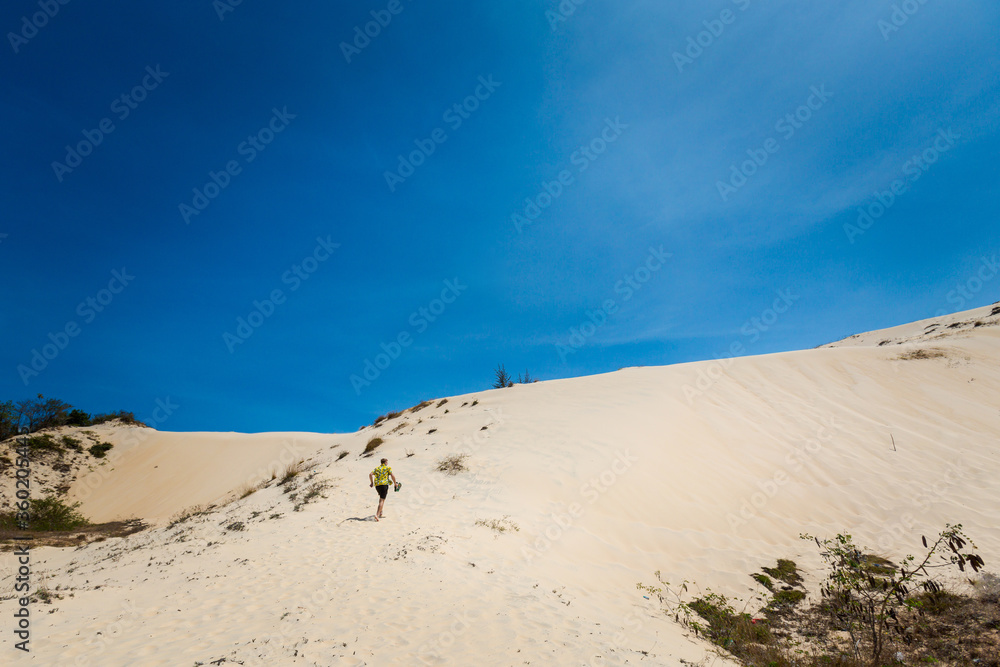 Young man on White sand dunes in Vietnam