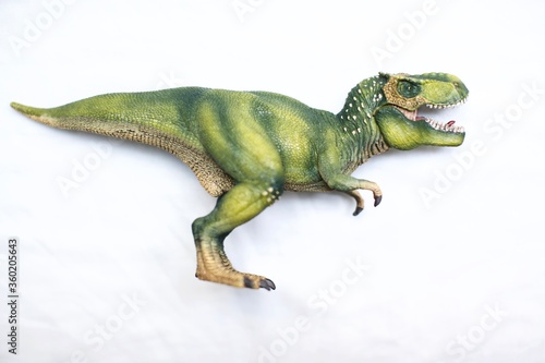 Plastic toy dinosaur of t-rex for kids. Vertical and horizontal view on white background.  © abu