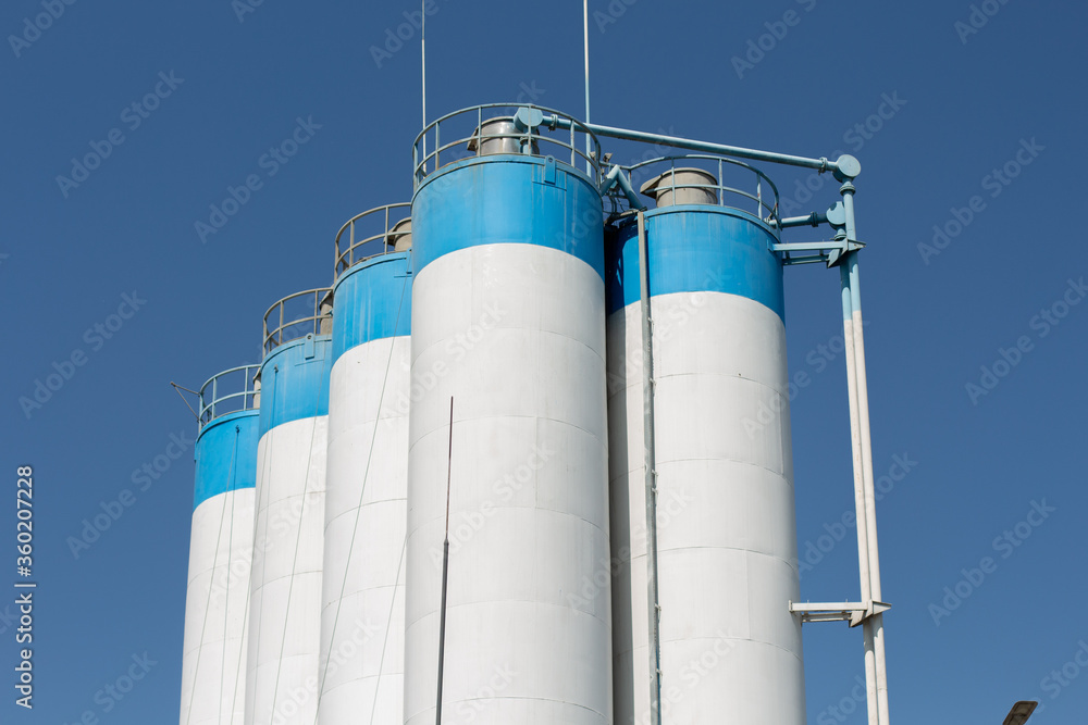 tall factory barrels and blue sky tall factory barrels and blue sky