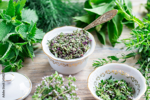 Fresh and dried herbs, lieves mix on wood table