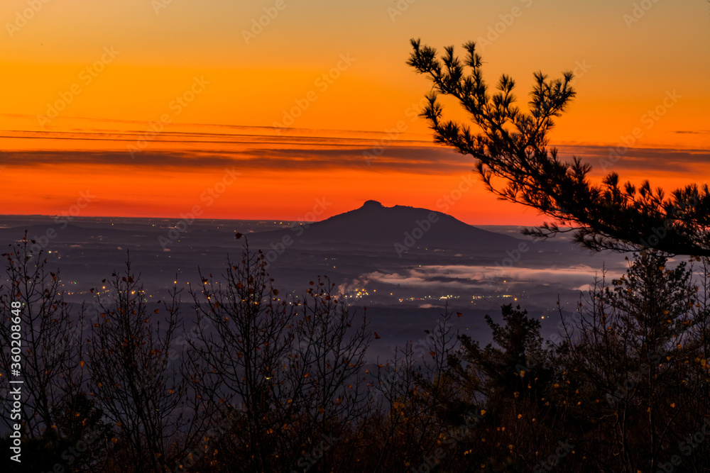 Silhouette of Pilot Mountain  against an orange sky.