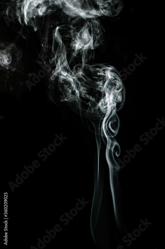 White puffed smoke in a dark background