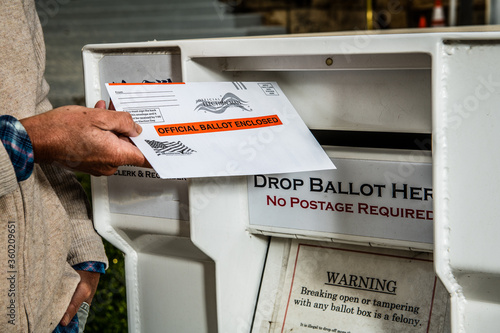 dropping mail-in ballot in ballot box photo