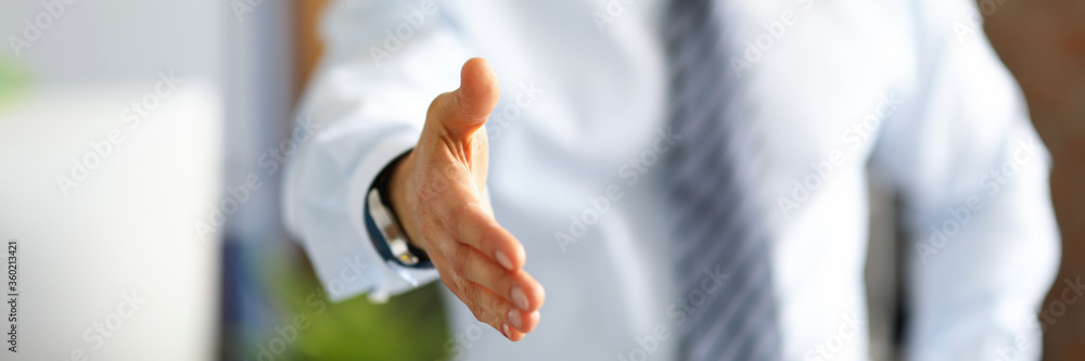 Businessman holds out his hand for a handshake