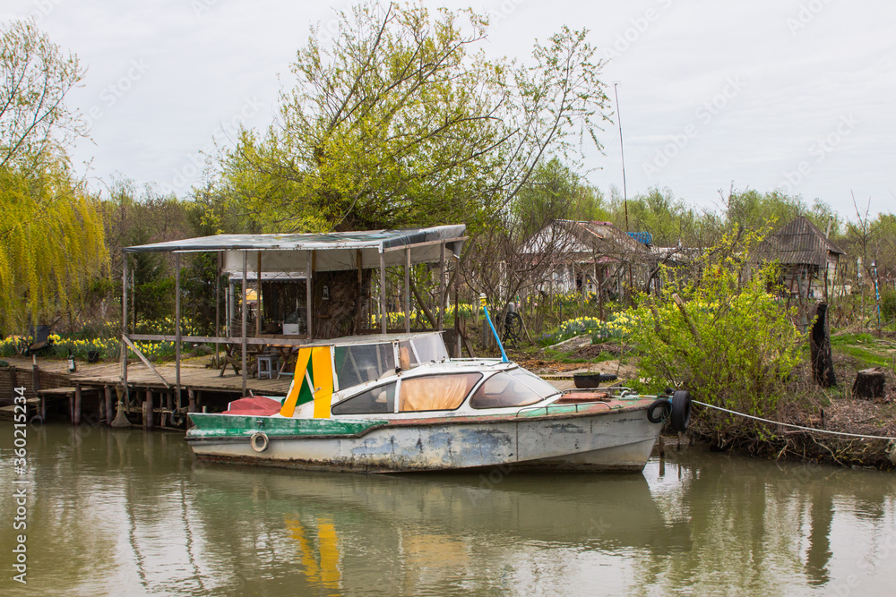 Motorboat in the Ukrainian city of Vilkovo. The city was built in the Danube Delta. People move on the water in boats. Motorboat in the Ukrainian city of Vilkovo. The city was built in the Danube Delta. People move on the water in boats.