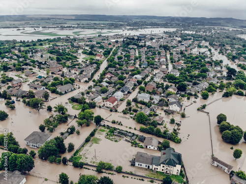 Flooded village on Ukraine. Natural disaster in village Halych, courtyards and streets in dirty water. Global catastrophe, climate change, flood concept photo