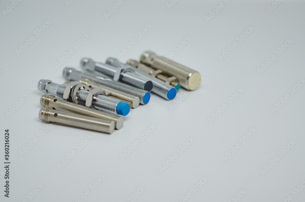 Many Inductive proximity sensor or proximity switch on a white background. Many Inductive proximity sensor or proximity switch on a white background.