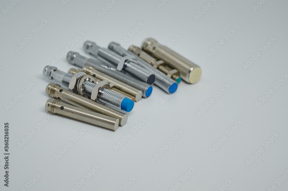 Many Inductive proximity sensor or proximity switch on a white background. Many Inductive proximity sensor or proximity switch on a white background.