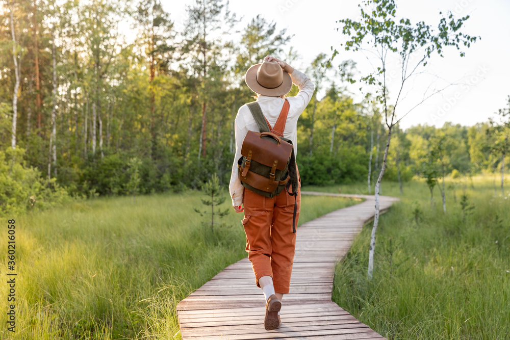 Ταπετσαρία Woman botanist with backpack on ecological hiking trail in summer outdoors