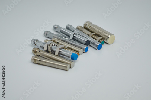 Many Inductive proximity sensor or proximity switch on a white background.