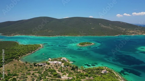 Aerial drone video of beautiful paradise island complex in gulf of Petalion that form a blue lagoon in South Evia island near Marmari, Greece photo