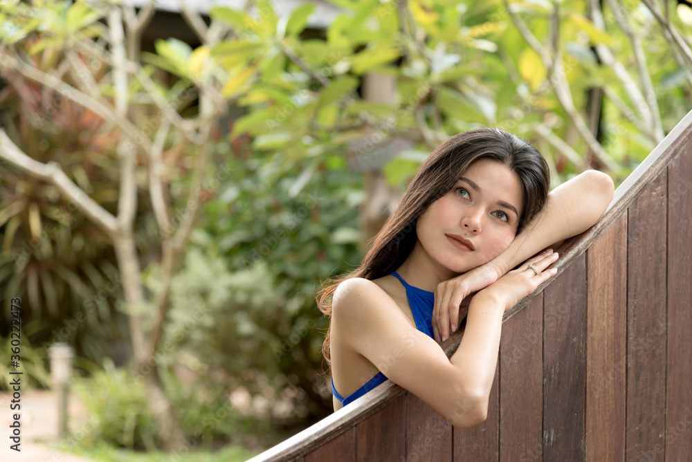 Naklejka premium Beautiful asian woman in swim suit stand relax in the garden,