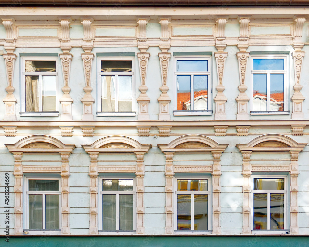 vintage building decorated facade with regular windows pattern