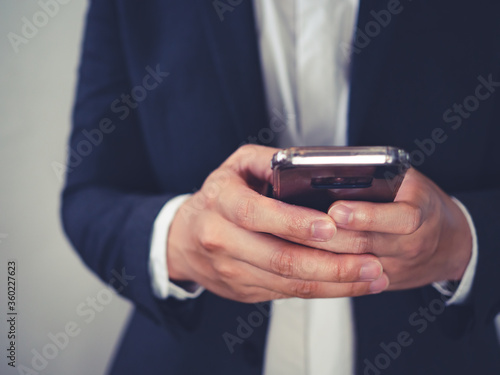 close up of business man using smartphone, concept of technology for business, network online. © Kenstocker
