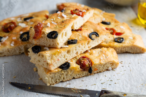 Bild auf Leinwand Homemade focaccia with black olives, cherry tomatoes, rosemary and salt
