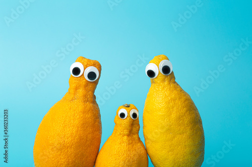 Funny lemons with eyes on a blue background. . Ugly food and ugly vegetables concept, food for kids (children), food face. Ugly food and ugly vegetables concept, food for kids (children).