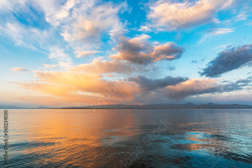 Beautiful sunrise on the lake with colorful clouds. Armenia Sevan lake