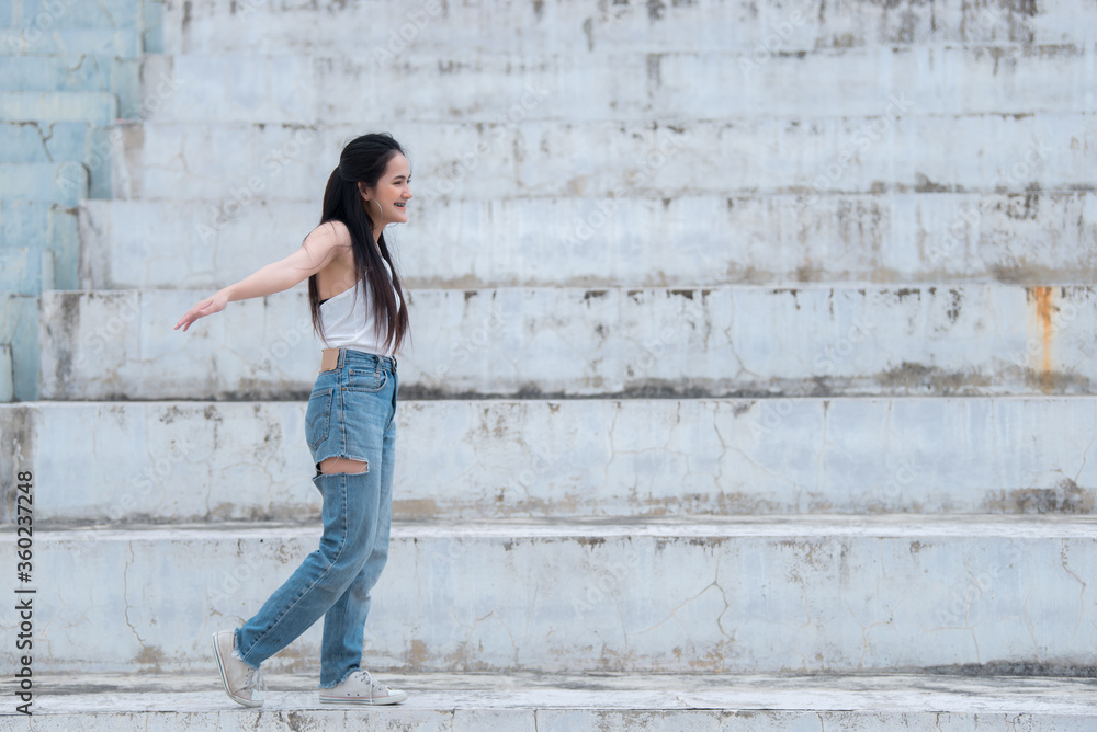 Portrait of beautiful asian chic girl pose for take a picture on wall background,Lifestyle of teen thailand people,Modern woman happy concept Portrait of beautiful asian chic girl pose for take a picture on wall background,Lifestyle of teen thailand people,Modern woman happy concept