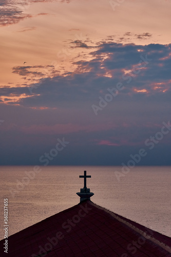 A silhouette of the cross atop St. George's Parish Church. 