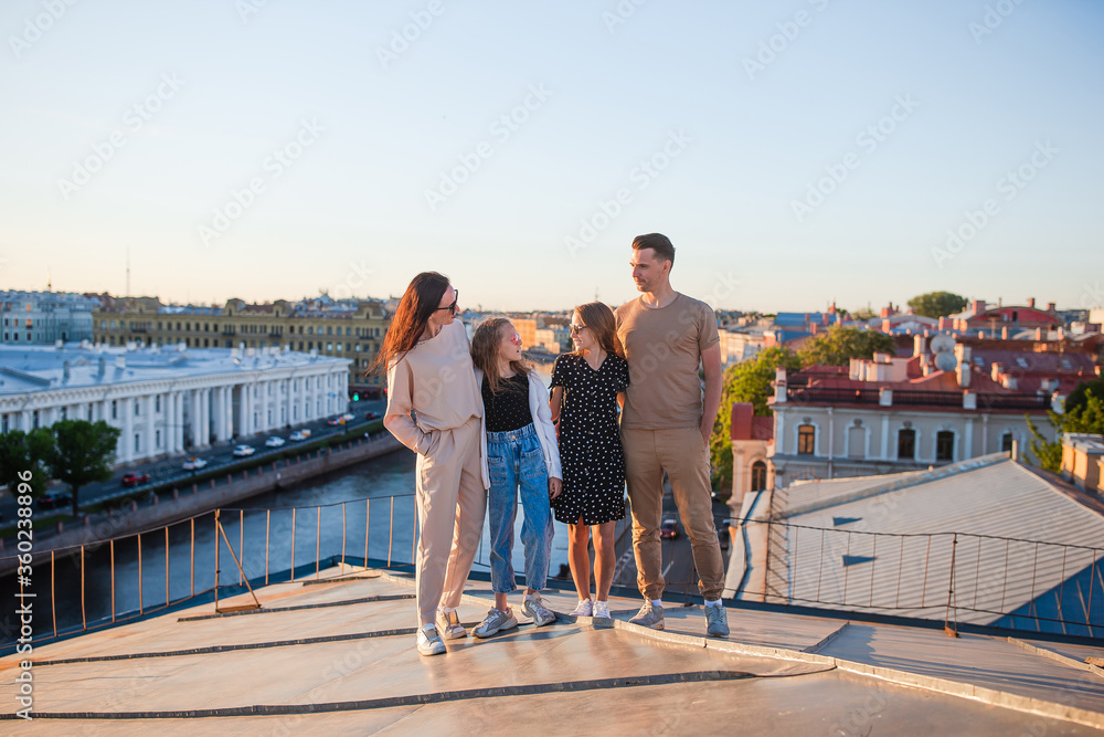 Family on rooftop enjoying with view of beautiful sunset in Sankt Petersburg in Russia Family on rooftop enjoying with view of beautiful sunset in Sankt Petersburg in Russia