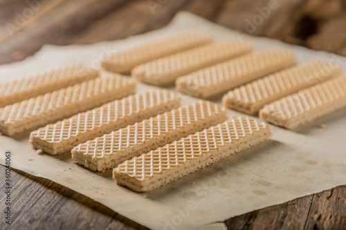 Heap of wafers in plate on an old wooden table