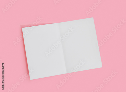 Empty white paper sheet for text on pink background. © Loraliu