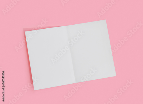 Empty white paper sheet for text on pink background.