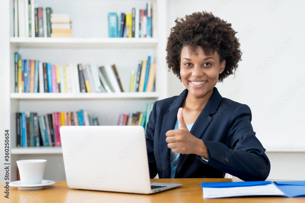 Happy african american business trainee working at computer Happy african american business trainee working at computer