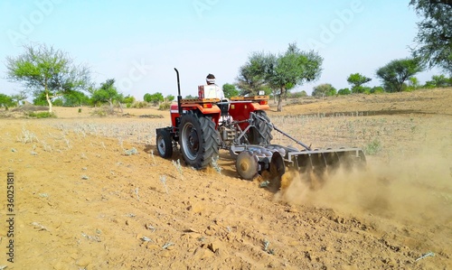 A tractor working in a field agriculture activities