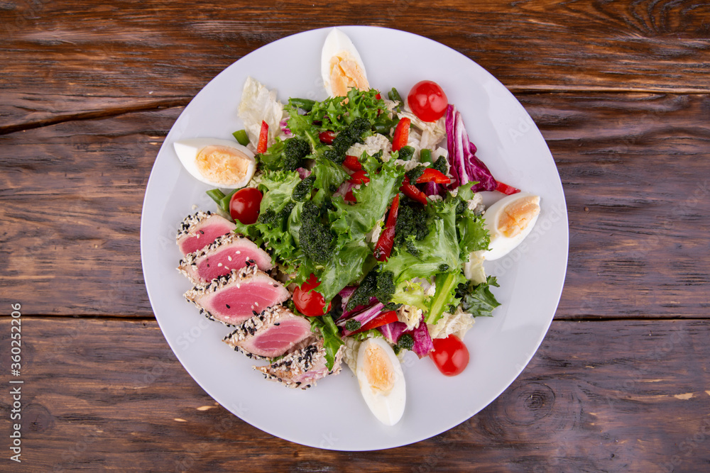 Vegetable salad with tuna, boiled egg, tomatoes and greens Vegetable salad with tuna, boiled egg, tomatoes and greens