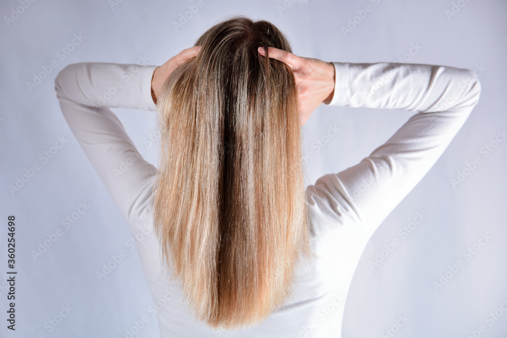 Woman with blonde shaggy hair change hairstyles with hands. Attractive skinny girl isolated on studio white. Cares about healthy and clean hair. Close up, selective focus Woman with blonde shaggy hair change hairstyles with hands. Attractive skinny girl isolated on studio white. Cares about healthy and clean hair. Close up, selective focus
