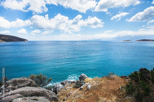 Coast of Crete, Greece. Blue waters of Mediterranean Sea and blue sky with clouds.