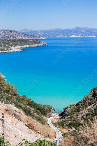  Staircase descent from mountain in blue sea. Mountain landscape. An island in Mediterranean.