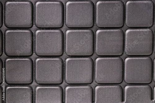Rubber texture background. Close-up of a detail of black rubber sandals or slippers with slip-resistant outsole. Macro photograph.