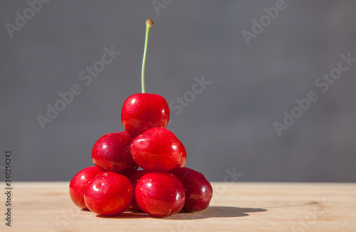 a handful of cherries on a gray background