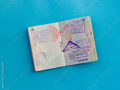 Open passport with several stamps from Thailand and Malaysia inside
