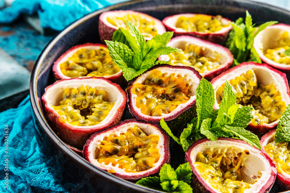 top view of fresh ripe delicious passion fruits with mint leaves top view of fresh ripe delicious passion fruits with mint leaves