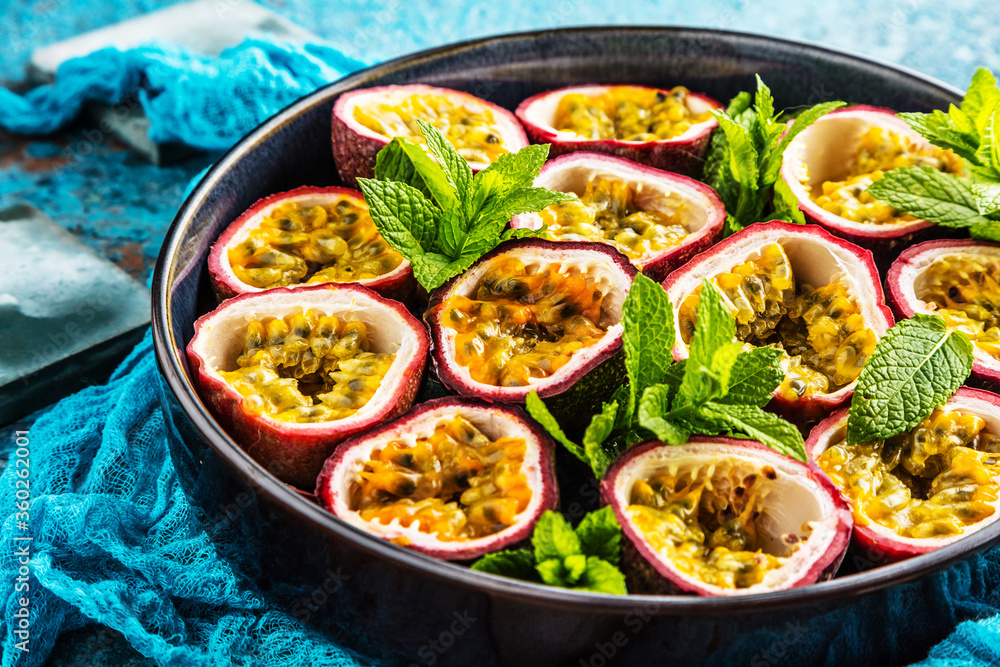 top view of fresh ripe delicious passion fruits with mint leaves top view of fresh ripe delicious passion fruits with mint leaves