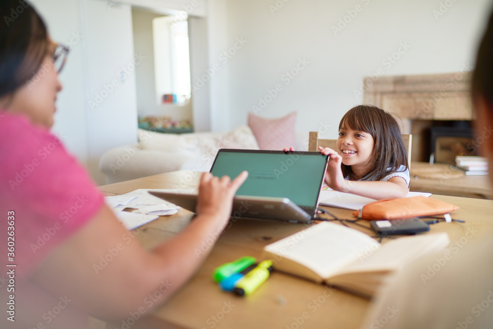 Daughter distracting mother working at laptop Daughter distracting mother working at laptop